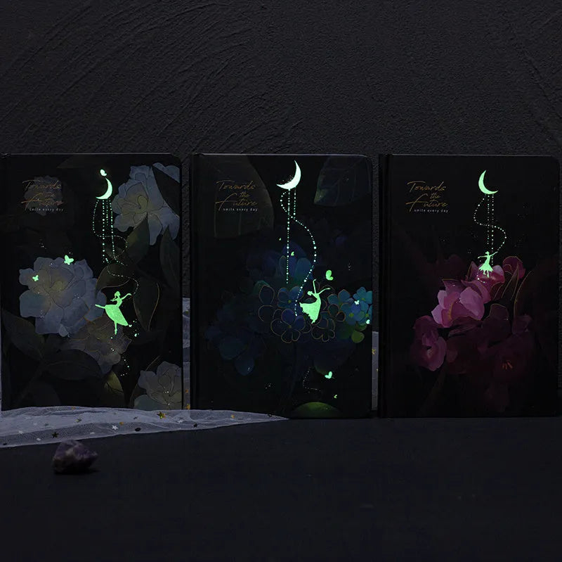 A5 notebook with luminous blue cover open to show colour illustration pages inside
