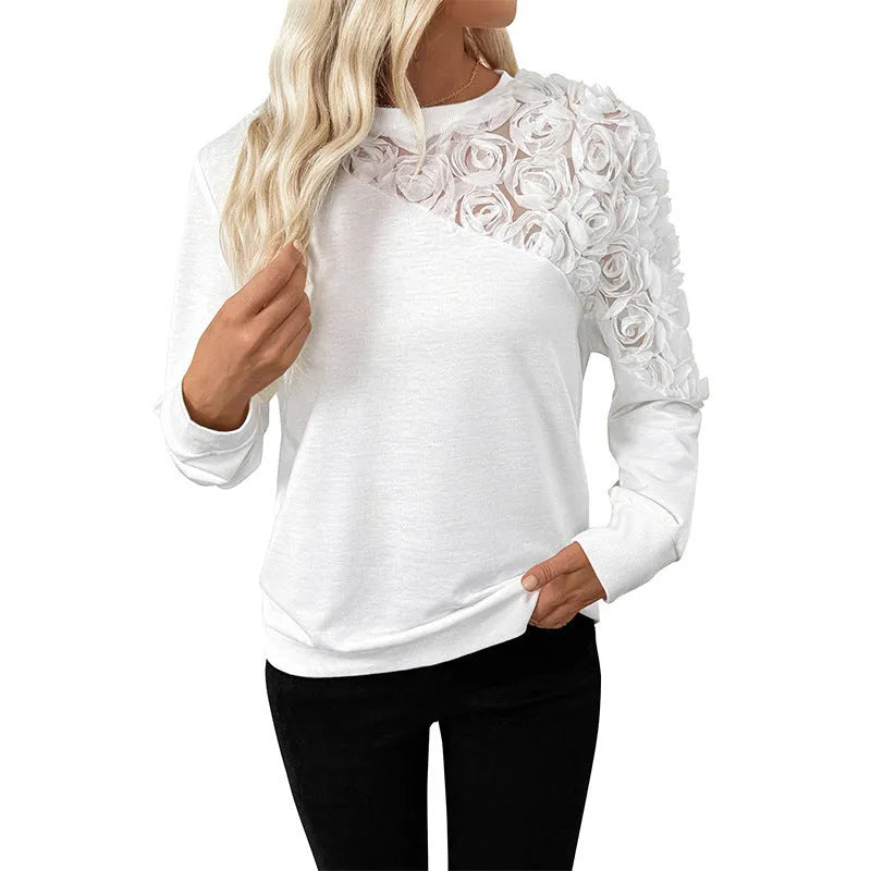 White women's long sleeve pullover top with floral pattern, loose fit.