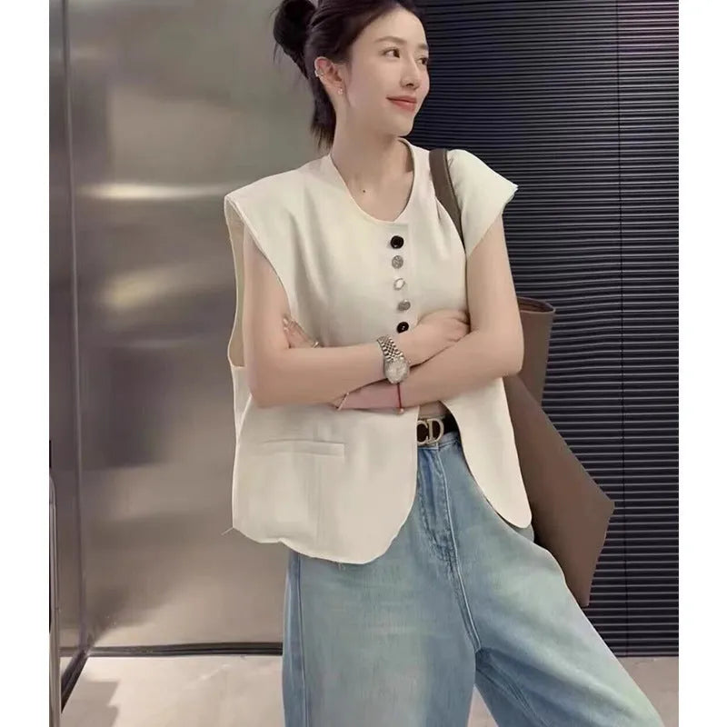 Women's loose-fitting solid colour polyester vest with a pocket, shown in milky white.