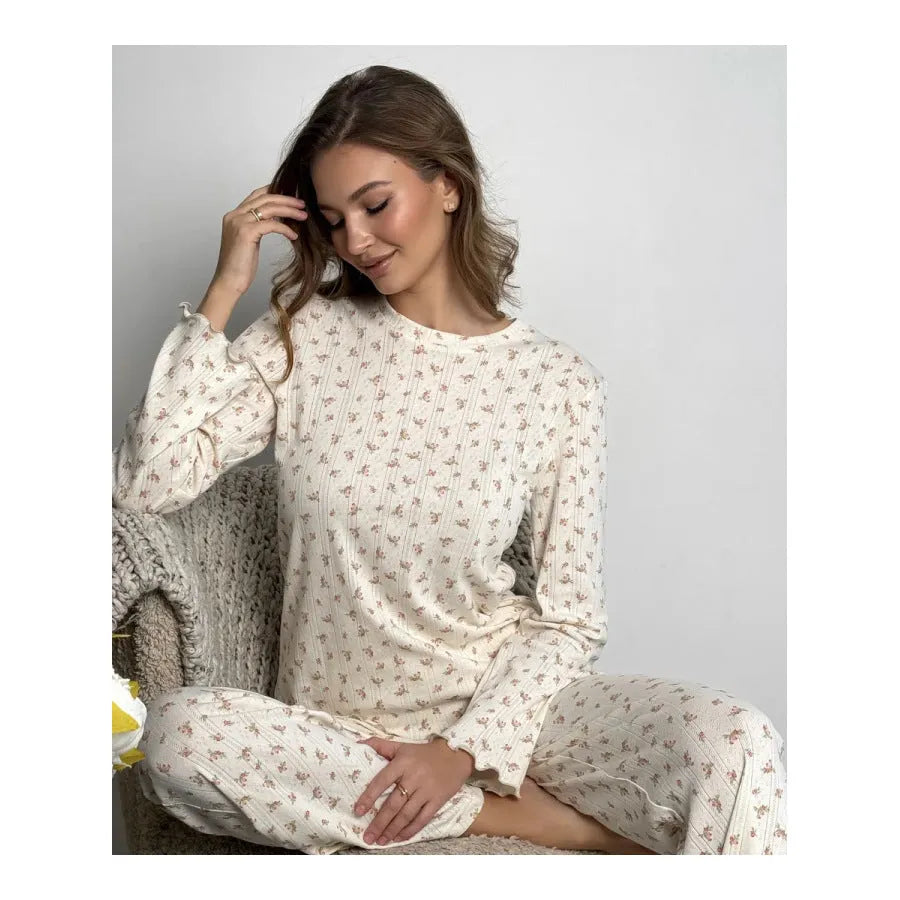 White floral print women's loungewear set with bell sleeve top and wide leg trousers.