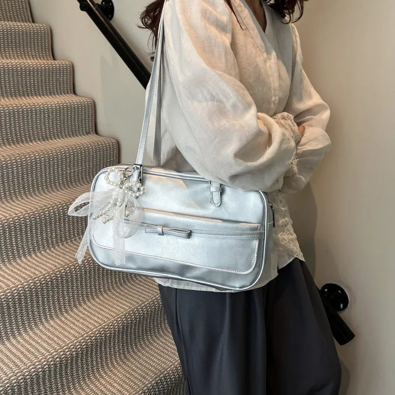 A horizontal square PU flap handbag in a solid colour with double-joint shoulder straps and optional pearl bow ornament.