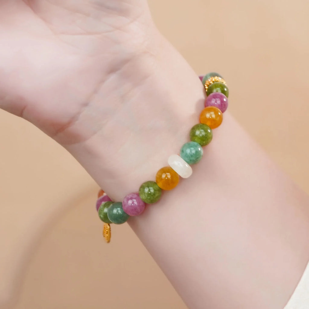 Natural rainbow coloured tourmaline gemstones on a women's jade pith half bracelet with electroplated finish.