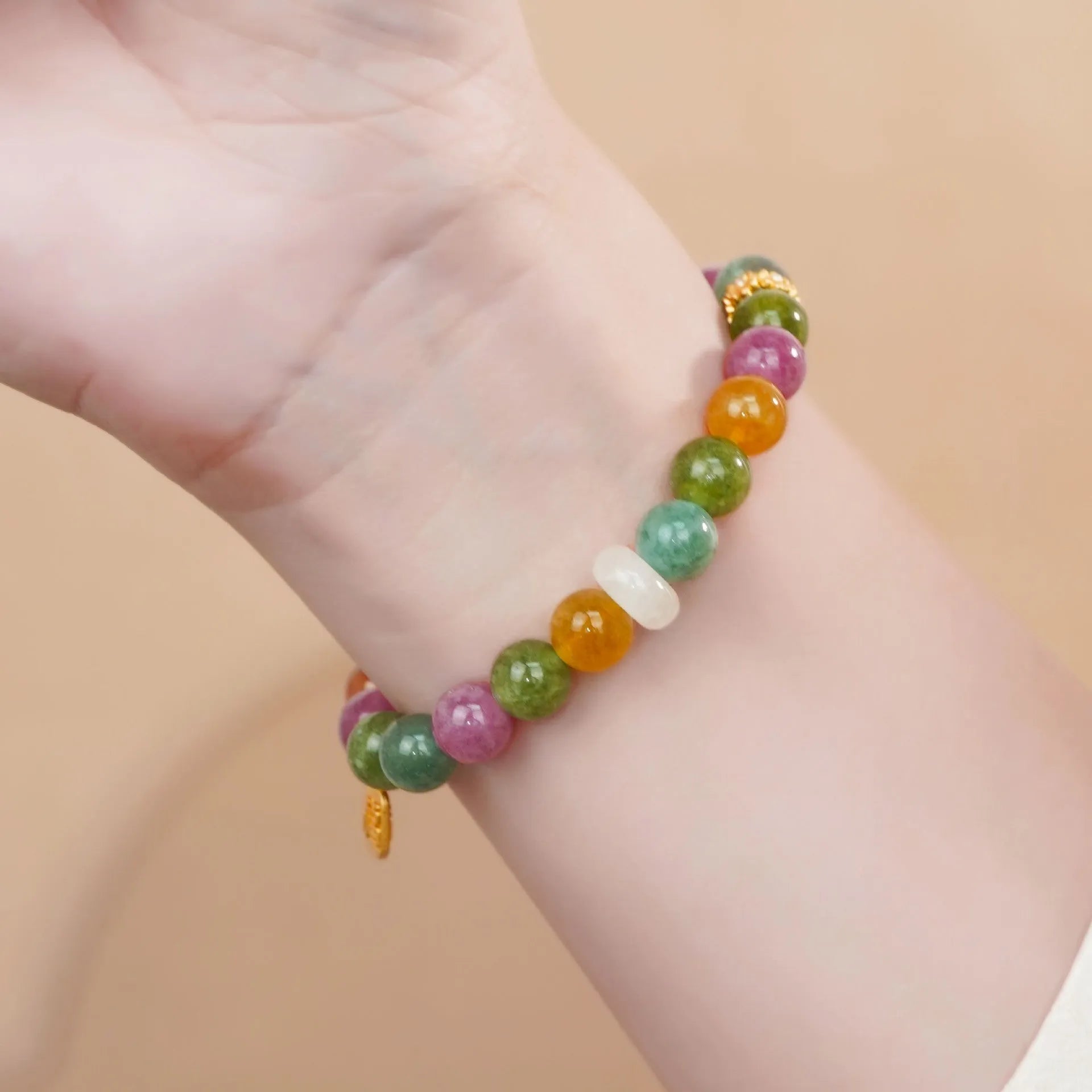 Natural rainbow coloured tourmaline gemstones on a women's jade pith half bracelet with electroplated finish.