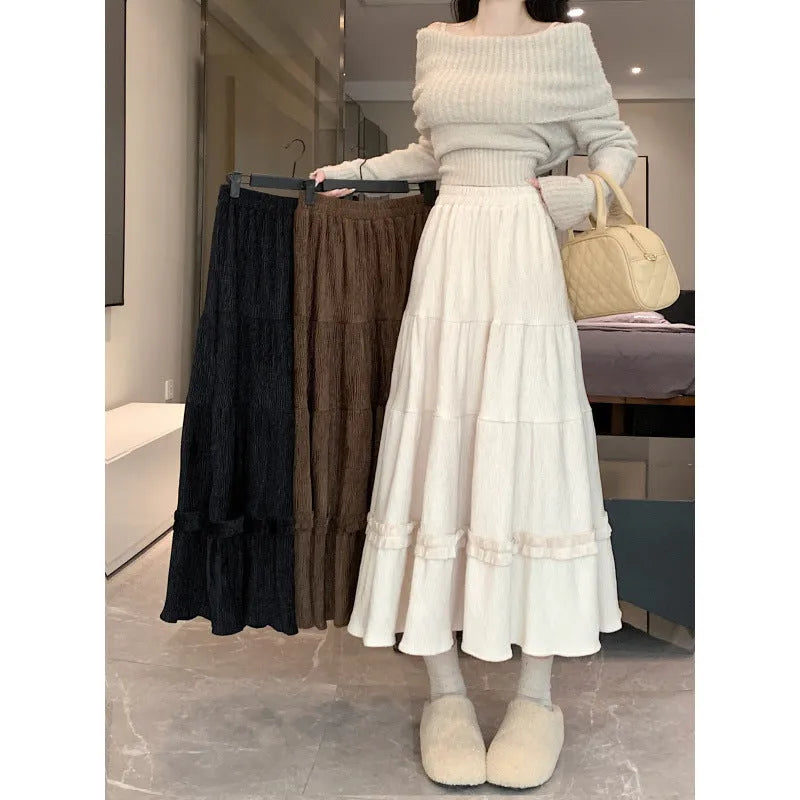 Beige corduroy A-line midi skirt with an elastic waistband laid flat.
