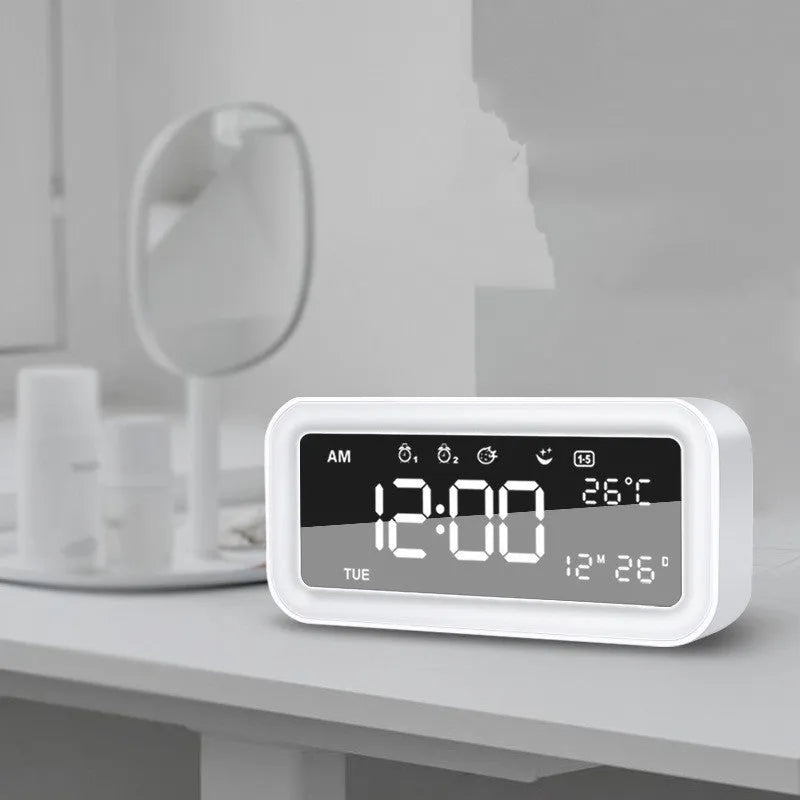 Rectangular blue LED alarm clock with digital display and multicoloured atmospheric lighting on bedside table