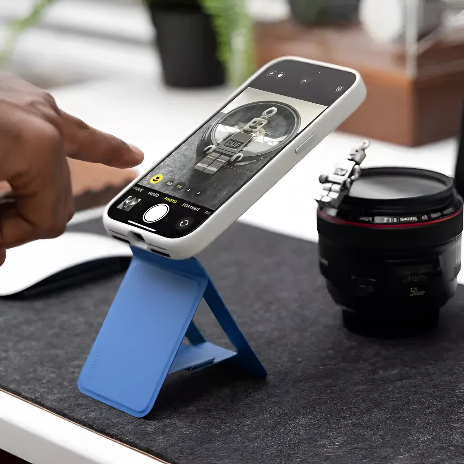 Black magnetic mobile phone holder case made from MOVAS leather and fibreboard, shown next to a phone.