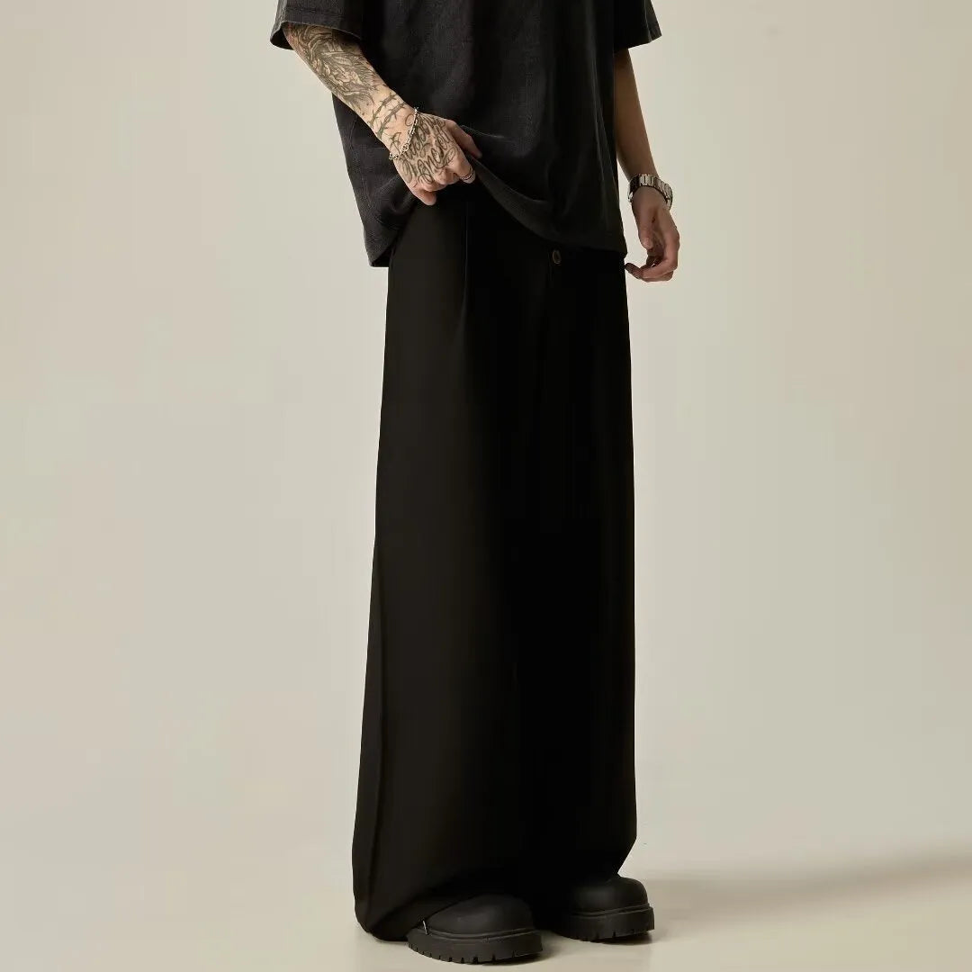 Man wearing black solid colour wide-leg casual trousers with a vertical tube design.