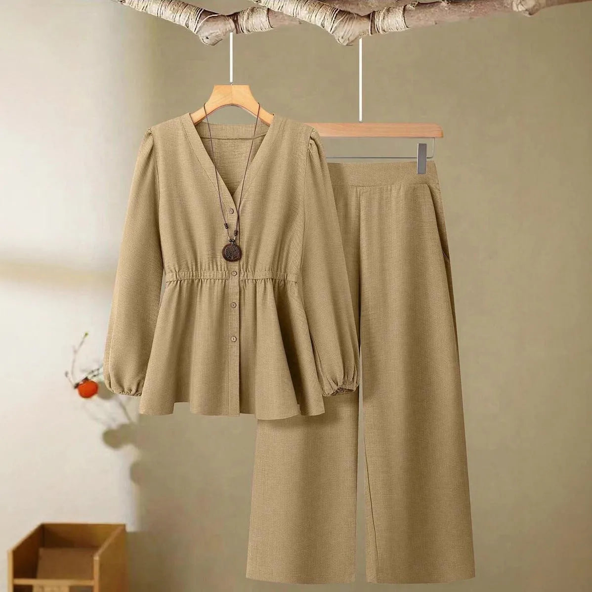 Women's long-sleeved two-piece polyester suit in khaki with button front top and matching trousers on model