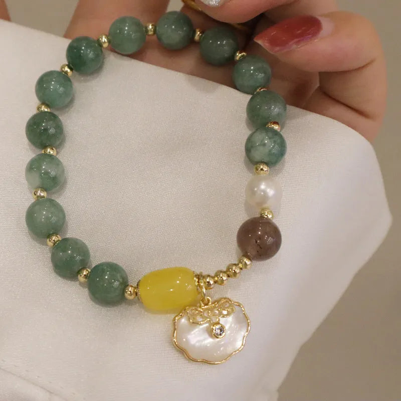 Green jade shell bracelet on a wrist showing natural stone beads and 18 cm length.