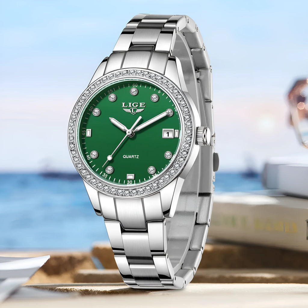 Silver-tone women's fashion watch with round dial, diamond bezel, and luminous hands on a wrist.