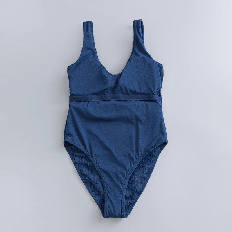 Navy blue women's one-piece triangle swimsuit with removable chest pads for swimming