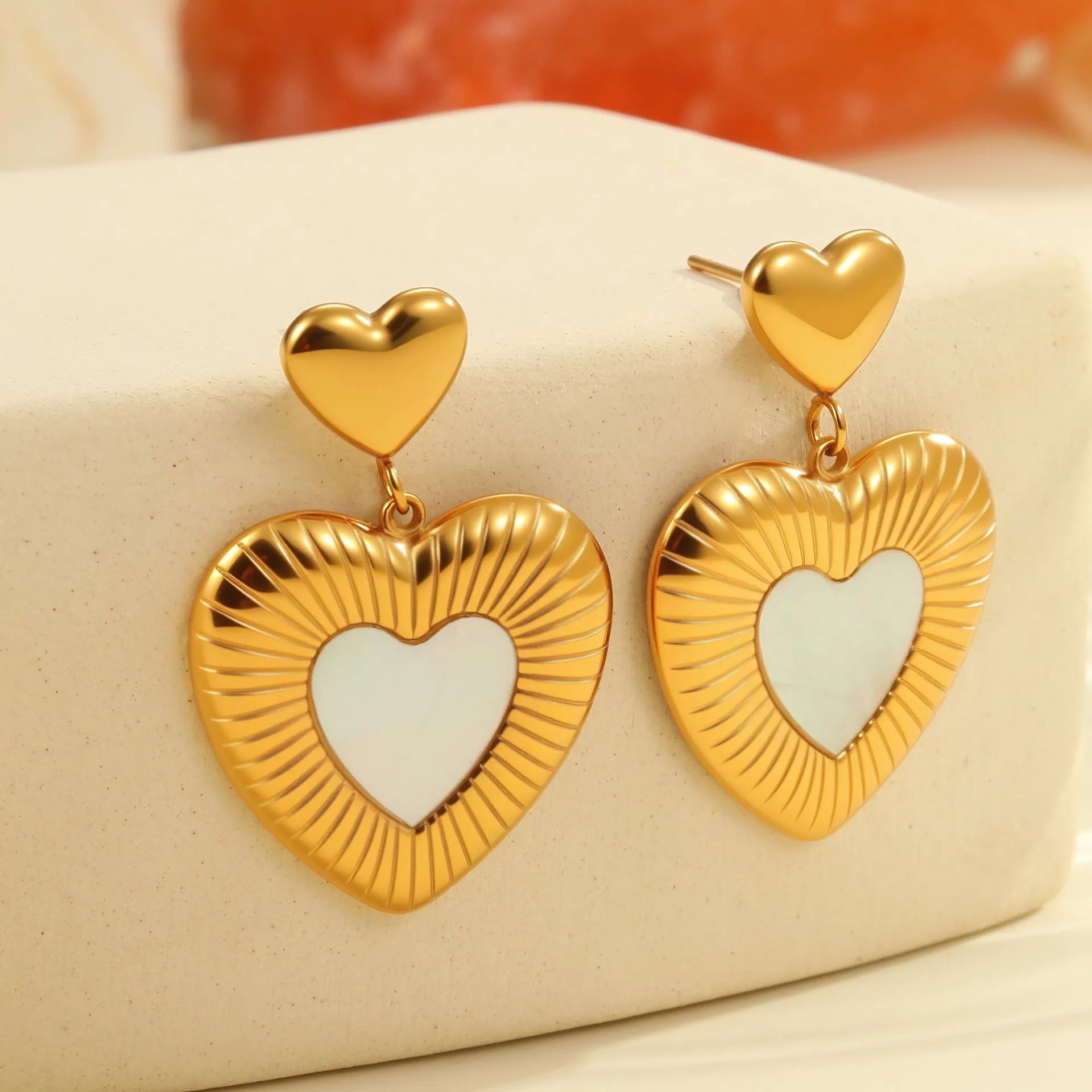 Heart shaped stainless steel earrings with white fritillary pattern and 18K gold electroplated finish
