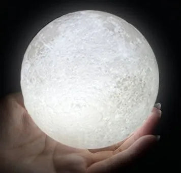 3D printed moon lamp on wooden stand with touch control ring at base, showing white and yellow light colours.