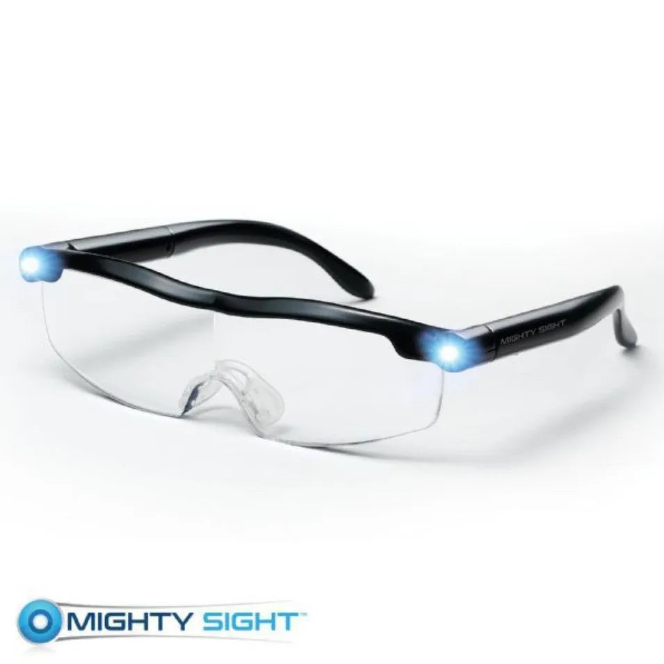 Transparent black USB LED reading glasses with illuminated frame on a desk