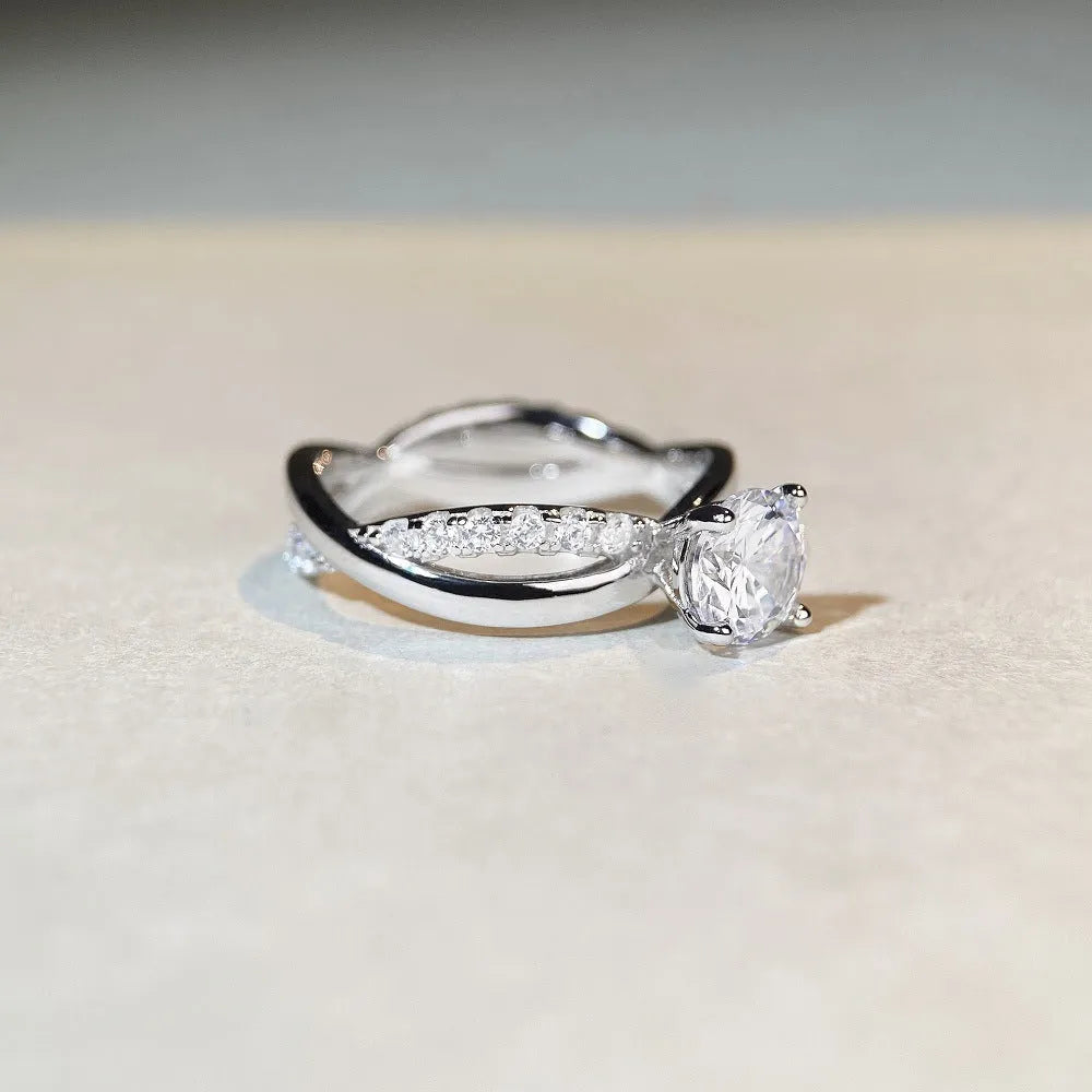 Geometric silver moissanite ring with twisted band and 1 karat centre stone in four-claw setting