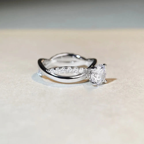 Geometric silver moissanite ring with twisted band and 1 karat centre stone in four-claw setting