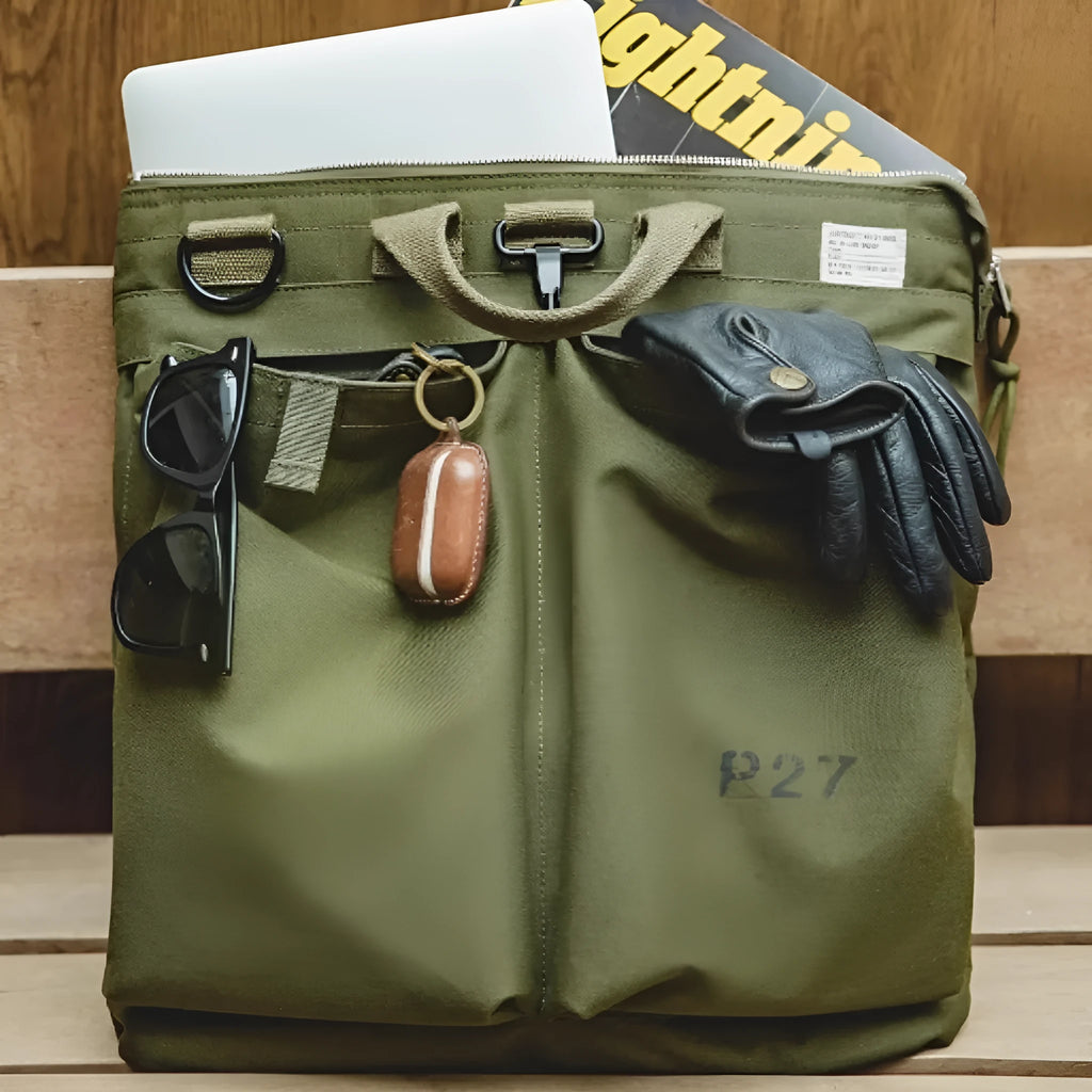 Marden Tooling Helmet canvas messenger crossbody bag in military green, showing vertical square shape and shoulder strap.