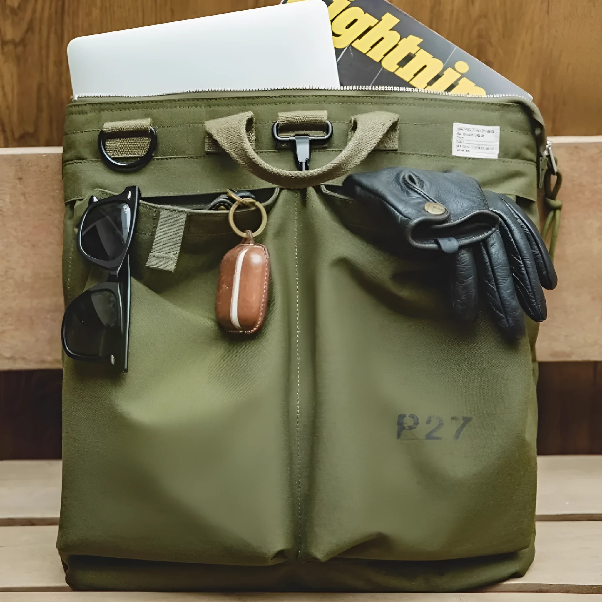 Marden Tooling Helmet canvas messenger crossbody bag in military green, showing vertical square shape and shoulder strap.