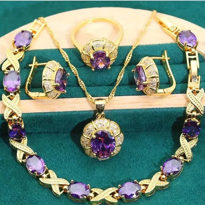 18k gold plated zircon jewellery set showing ring, earrings, bracelet and necklace in a coordinating colour.