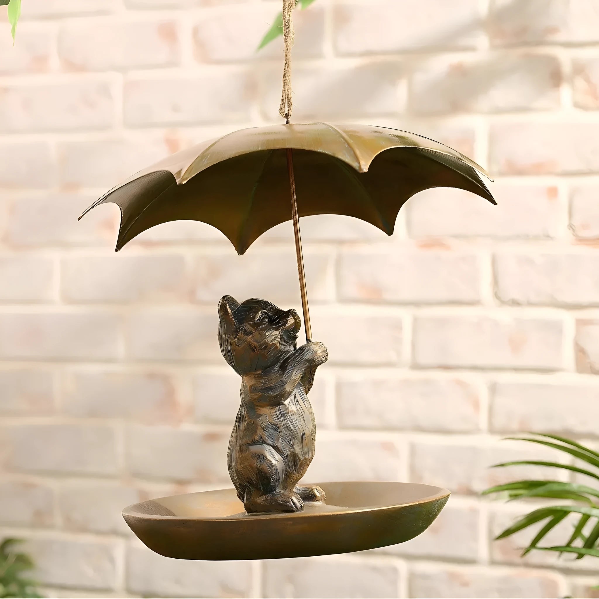 Umbrella shaped bird feeder in cat colour option, 10x10x9cm, casting construction, on a wooden table
