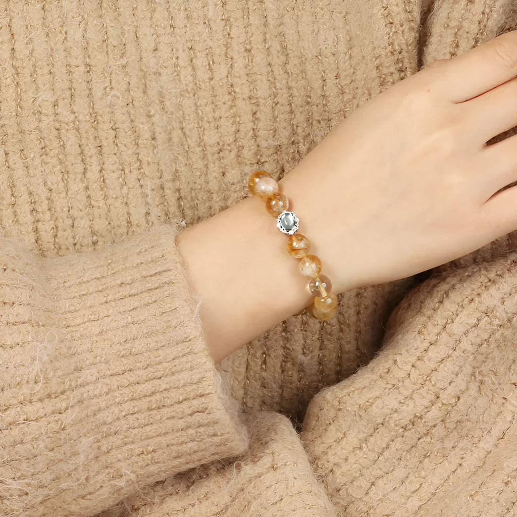 Geometric citrine crystal bracelet with 10mm stones on a wrist.