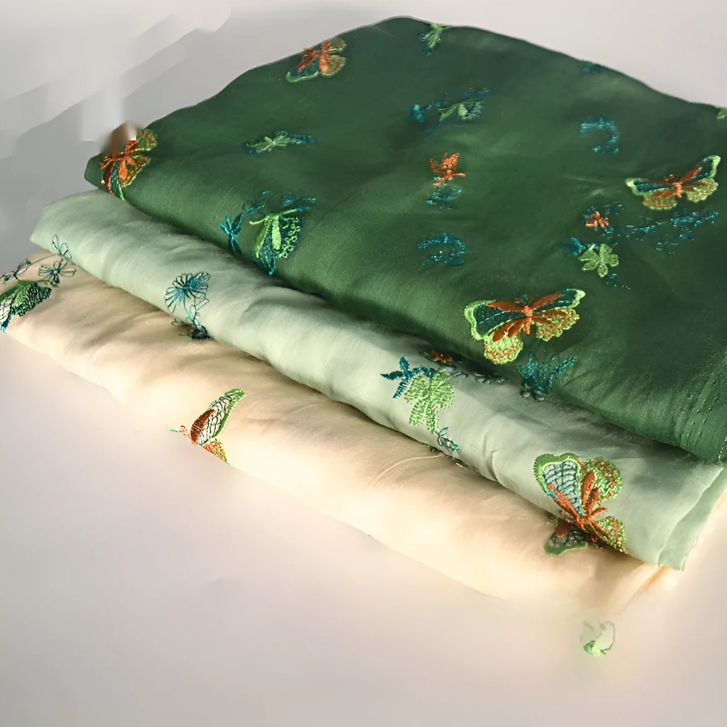 Pure ramie hanfu fabric in beige, dark green and grass green colours showing texture