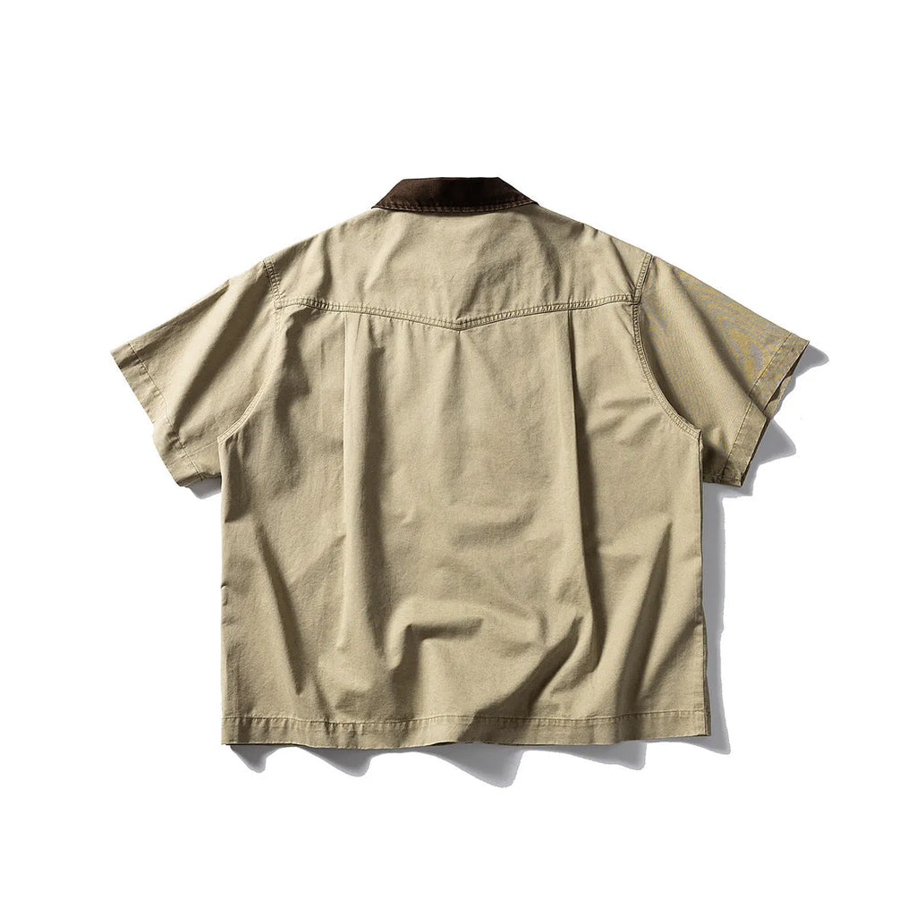 Washed khaki cotton overalls shirt with short sleeves and loose cardigan style on a hanger