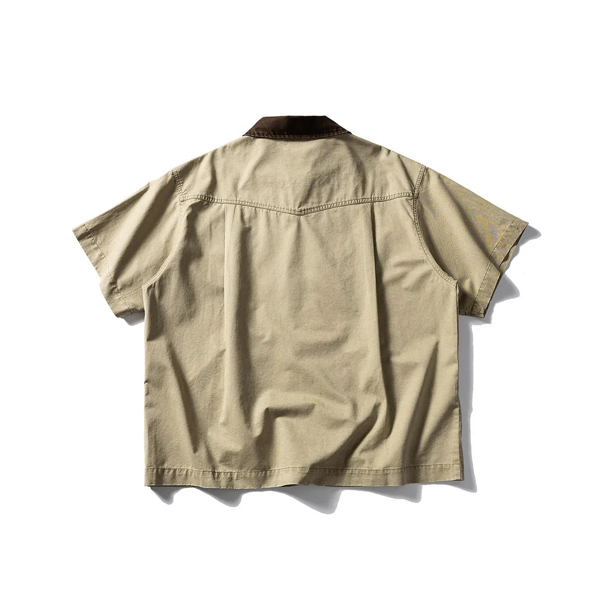Washed khaki cotton overalls shirt with short sleeves and loose cardigan style on a hanger