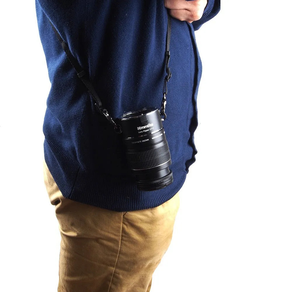 Aluminium alloy camera lens flipper holder with stainless steel buckle on a cotton shoulder strap.