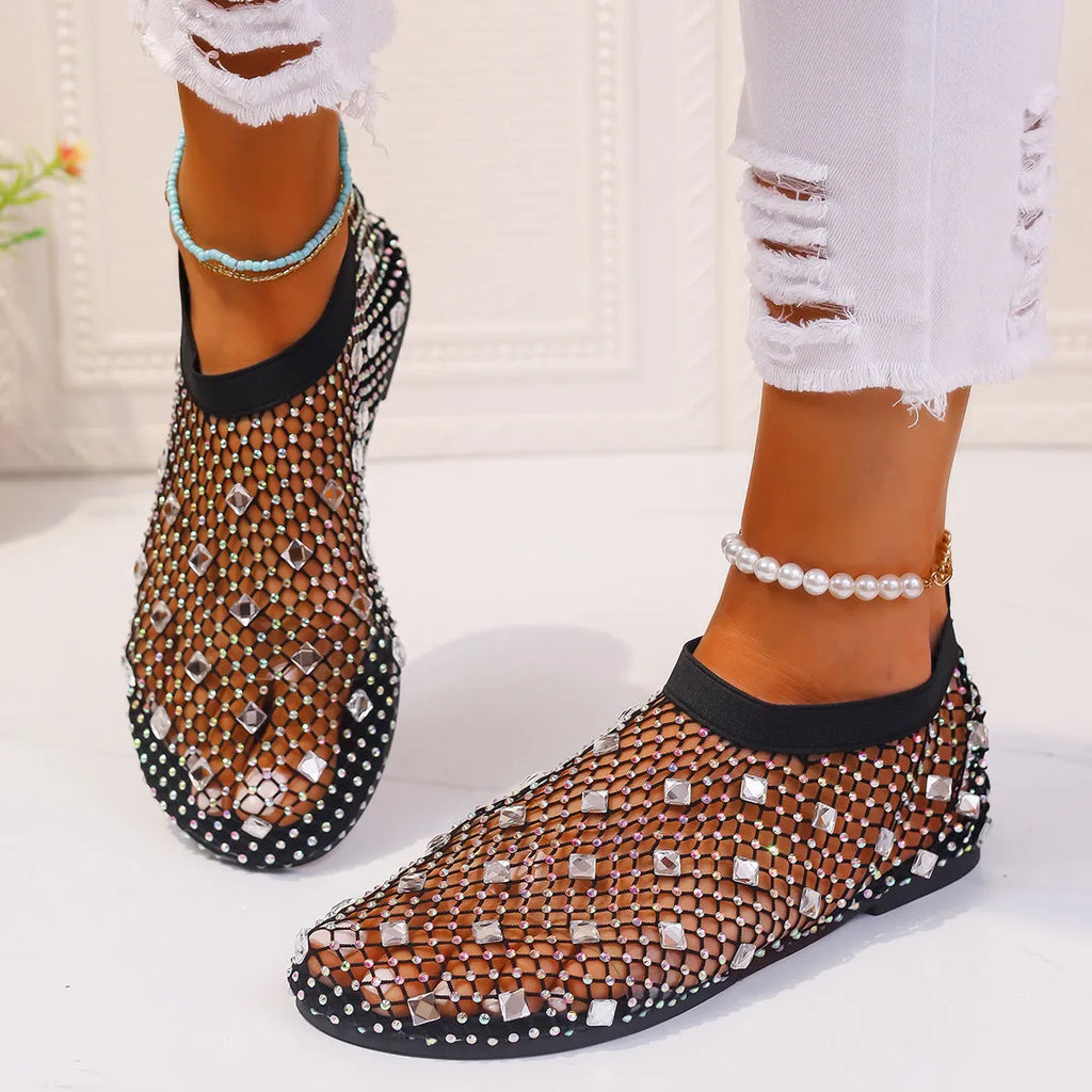 Colourful rhinestone detail on women's mesh flat sandals with round toe and rubber sole.