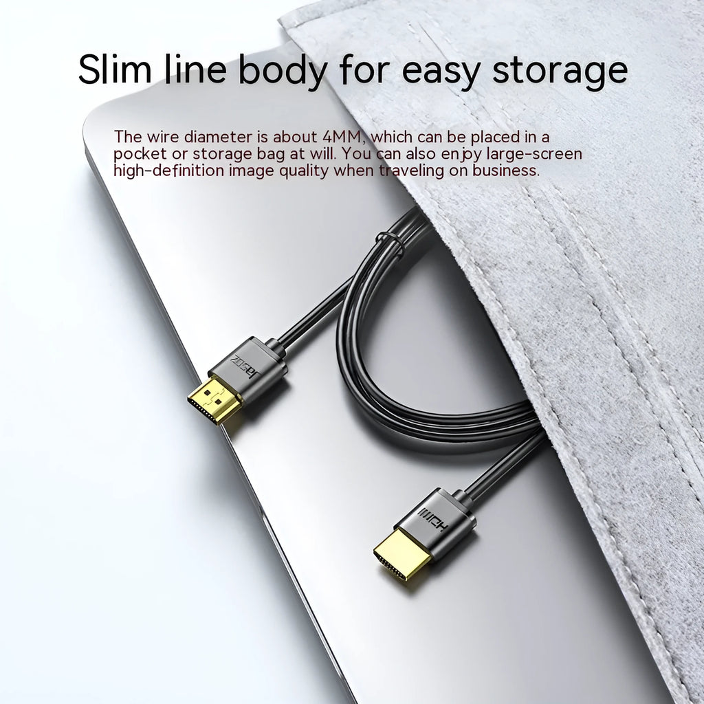 Thin flexible HDMI cable with gold-plated connectors on a white background.