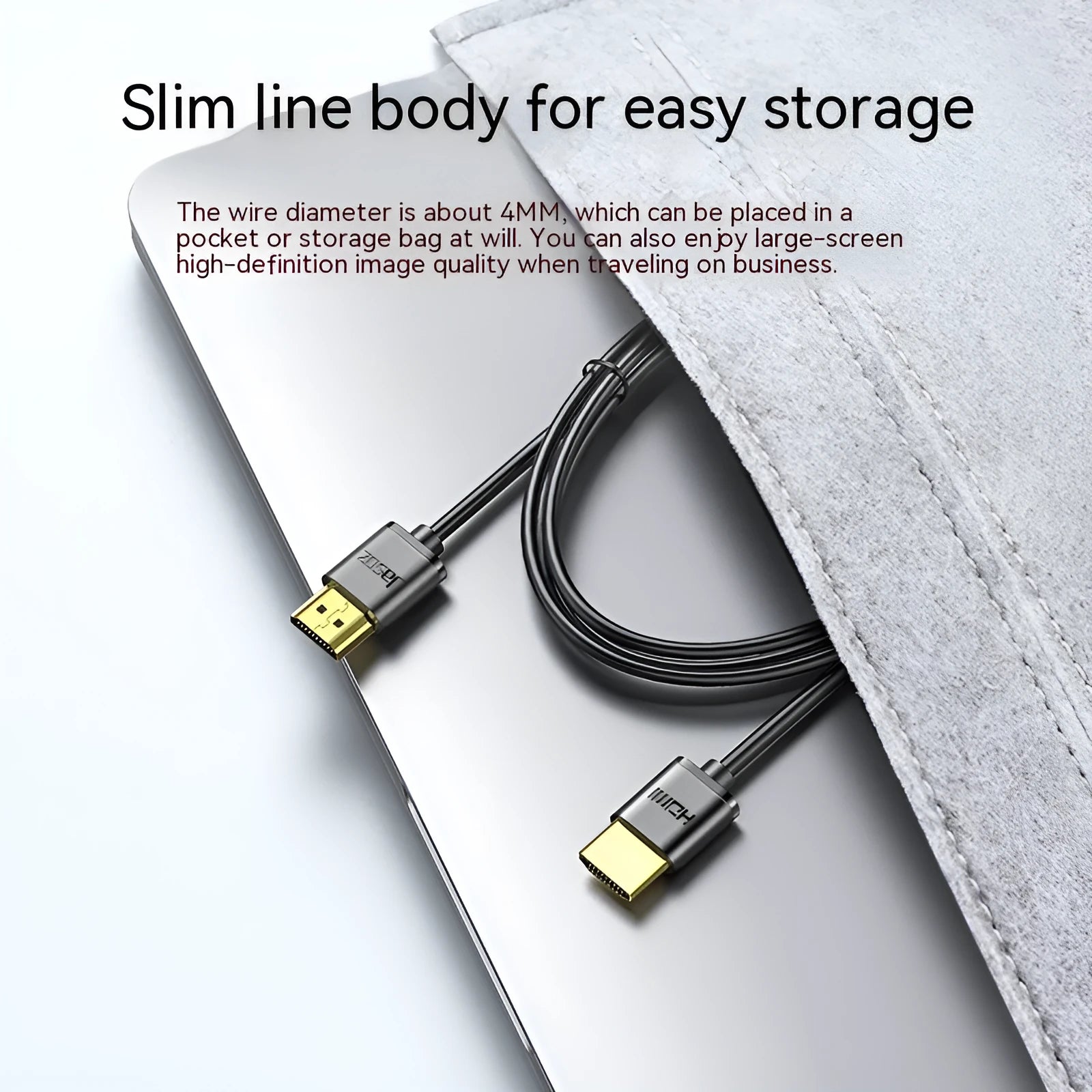 Thin flexible HDMI cable with gold-plated connectors on a white background.