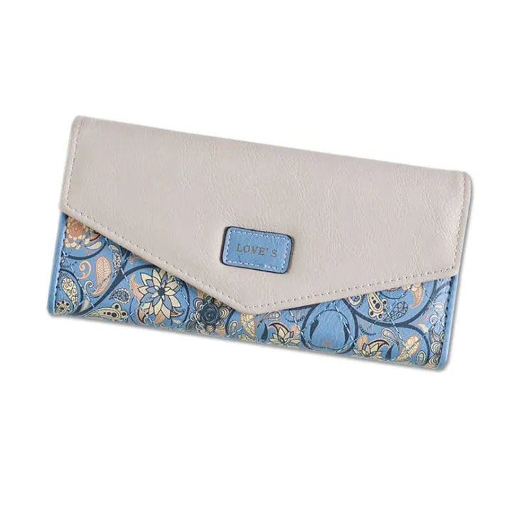 Women's large black three-fold PU leather wallet with buckle closure showing card slots.
