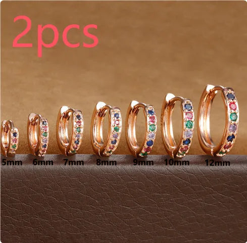 Round zircon geometric stud earrings in gold, rose gold, and silver colours on a white background.