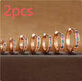 Round zircon geometric stud earrings in gold, rose gold, and silver colours on a white background.