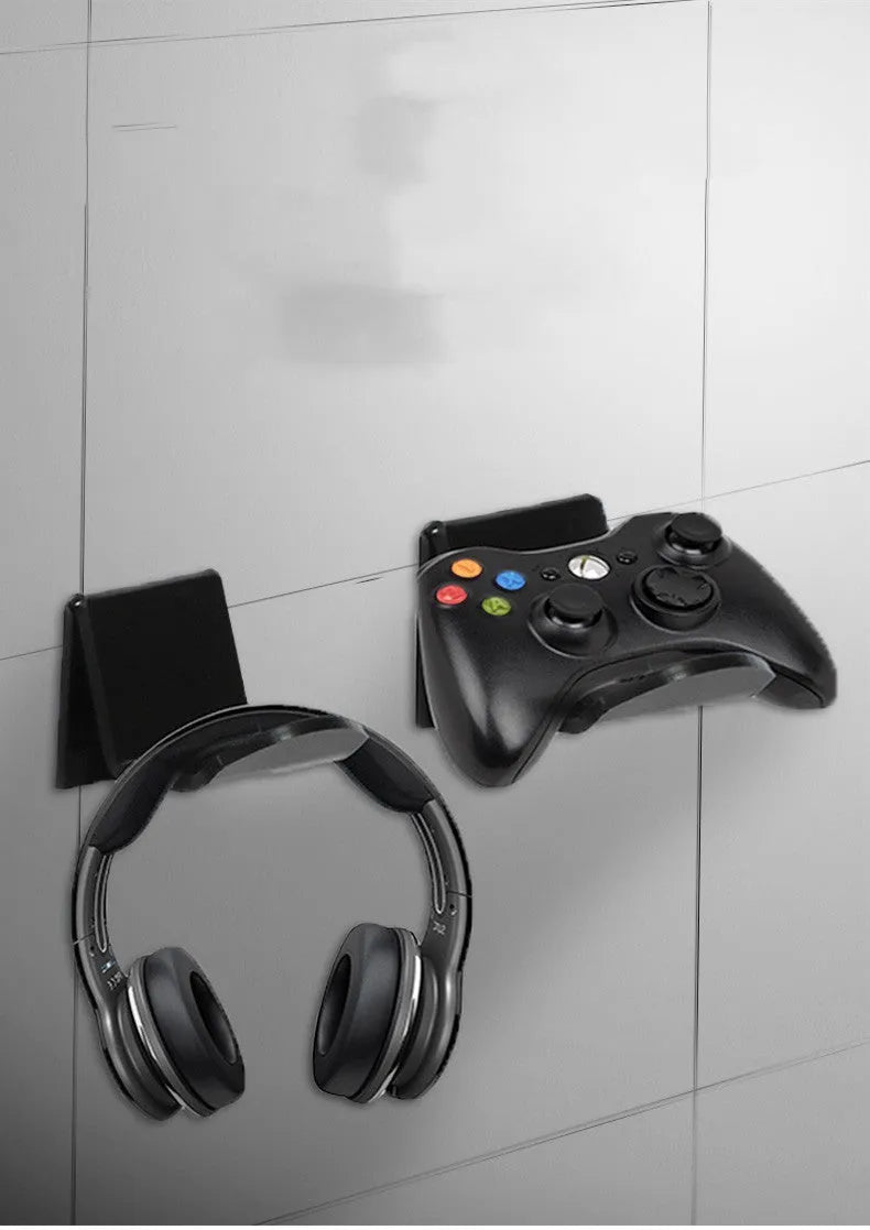 Universal plastic game controller bracket mounted on a wall in a choice of black, white, or transparent.