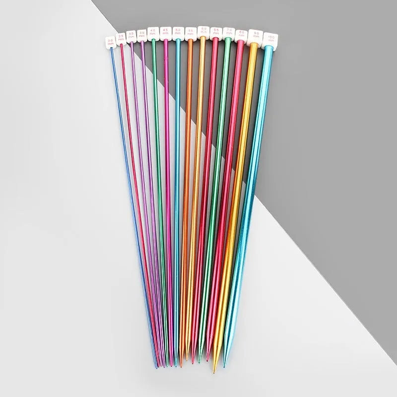 Complete set of aluminium crochet hooks in 14 sizes with protective caps laid out on a table.