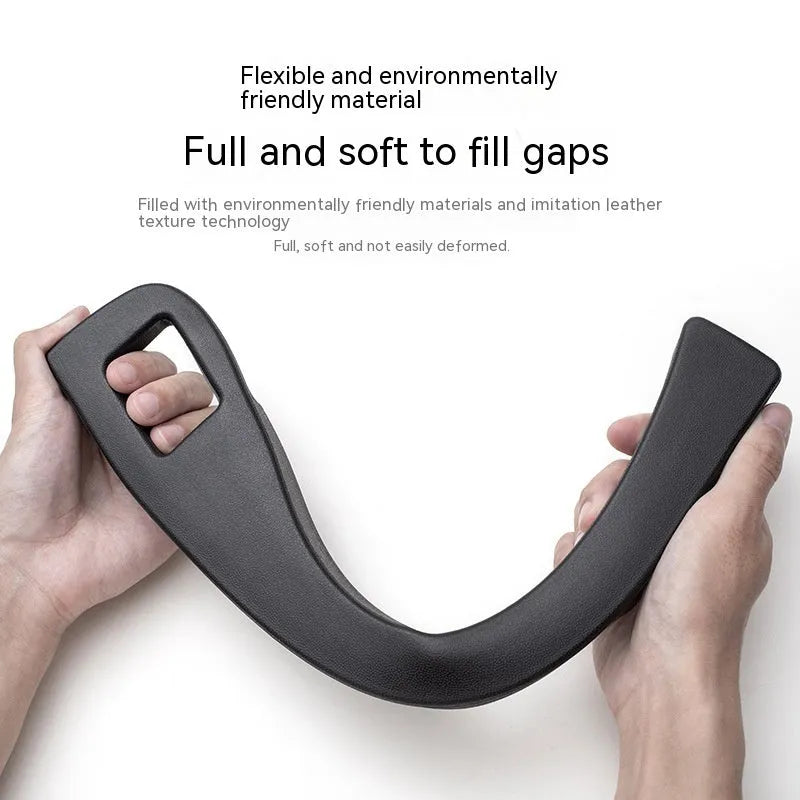 Black plastic car seats gap storage box with handle between driver seat and centre console