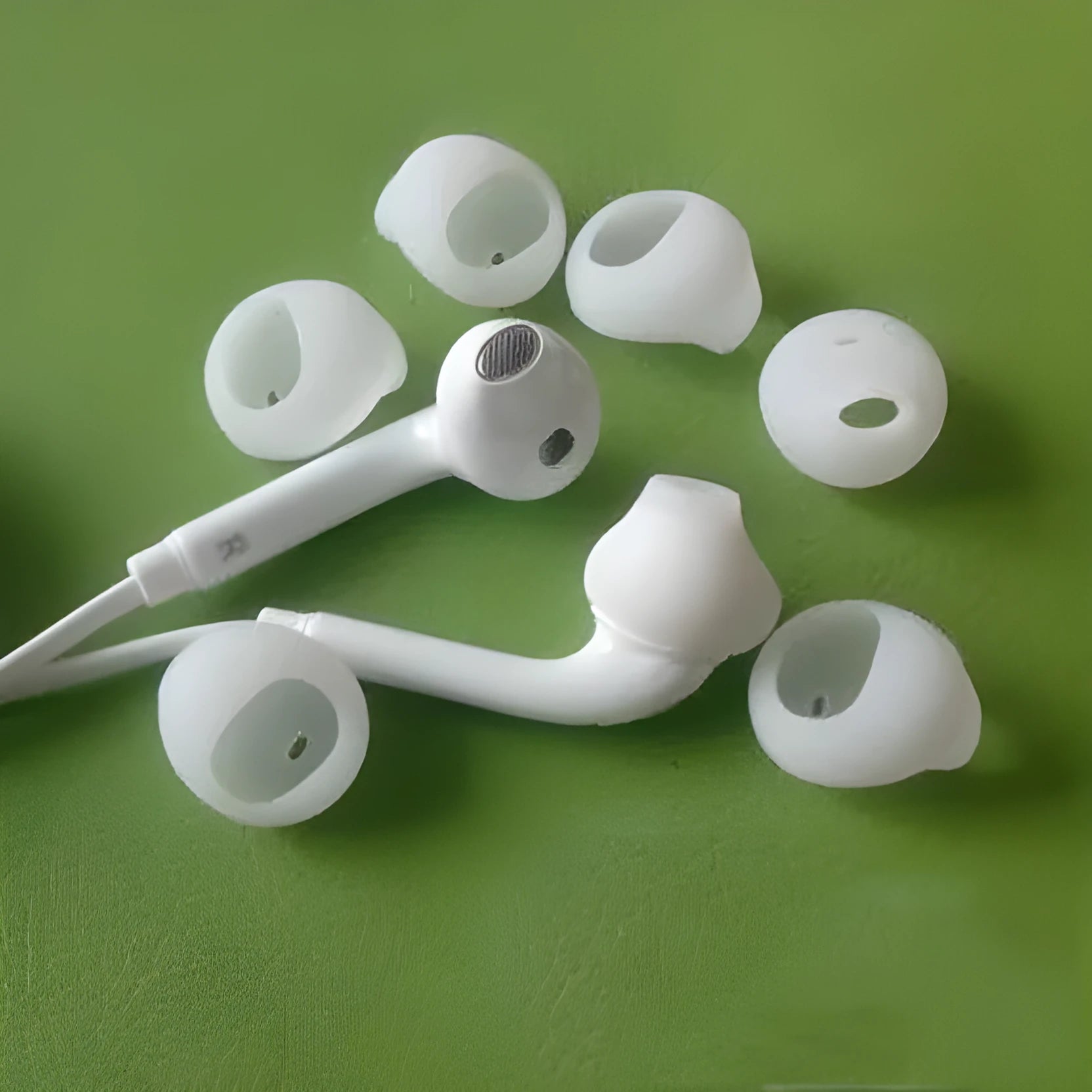Black and white silicone protective sleeves for Galaxy S6 Edge in-ear headphones.