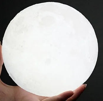 3D printed moon lamp on wooden stand with touch control ring at base, showing white and yellow light colours.
