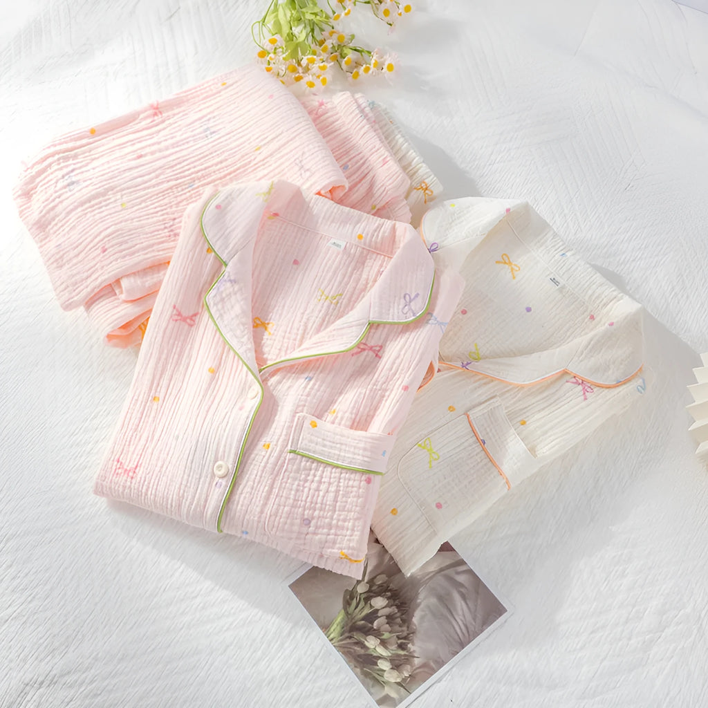 Women's thin cotton long-sleeve pajama set in pink, showing top and trousers.