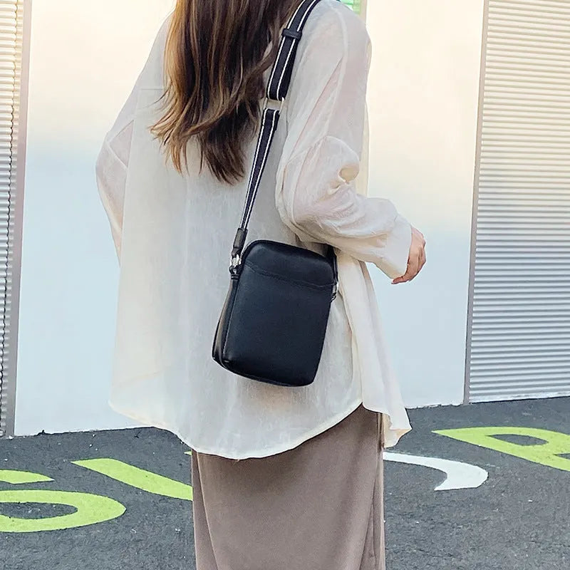 Simple solid colour PU leather crossbody phone bag for women shown in beige.
