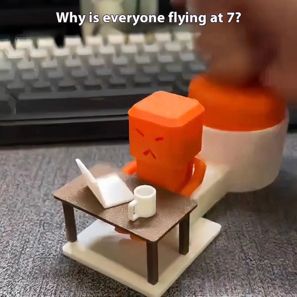 Orange plastic table turning decompression toy artefact on a flat surface.
