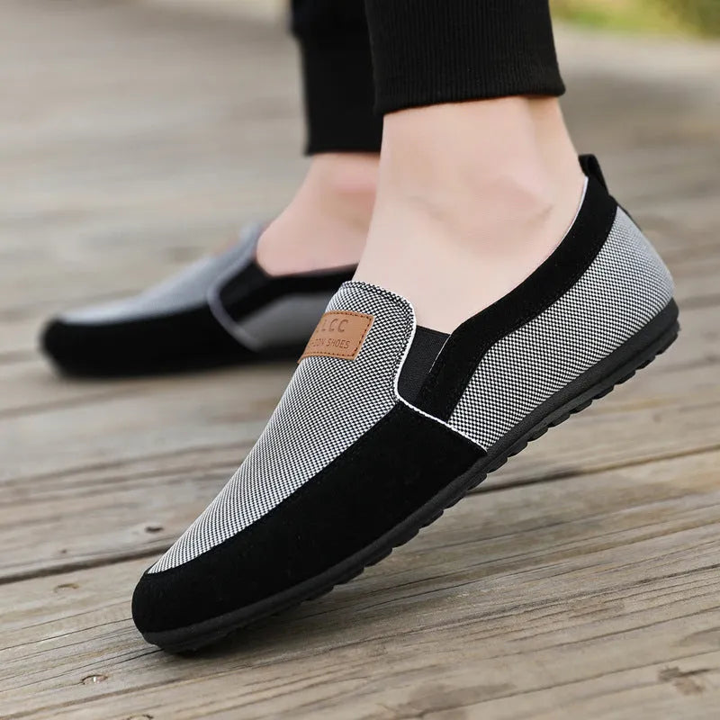 Men's grey canvas casual board shoes with round toe and rubber sole.