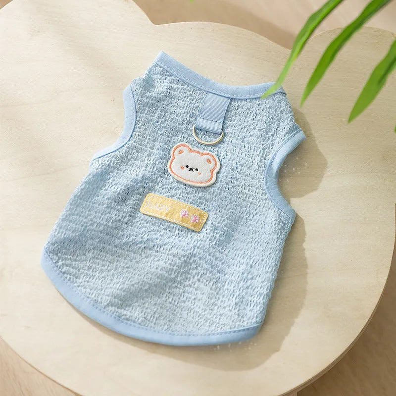 Blue knitted cat clothing with a bear patch, showing hollowed-out breathable design