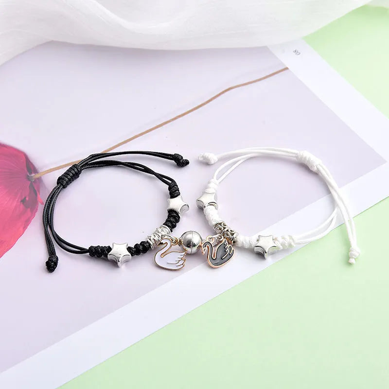A pair of matching magnetic suction bracelets with an alloy electroplated finish, showing a sample design.