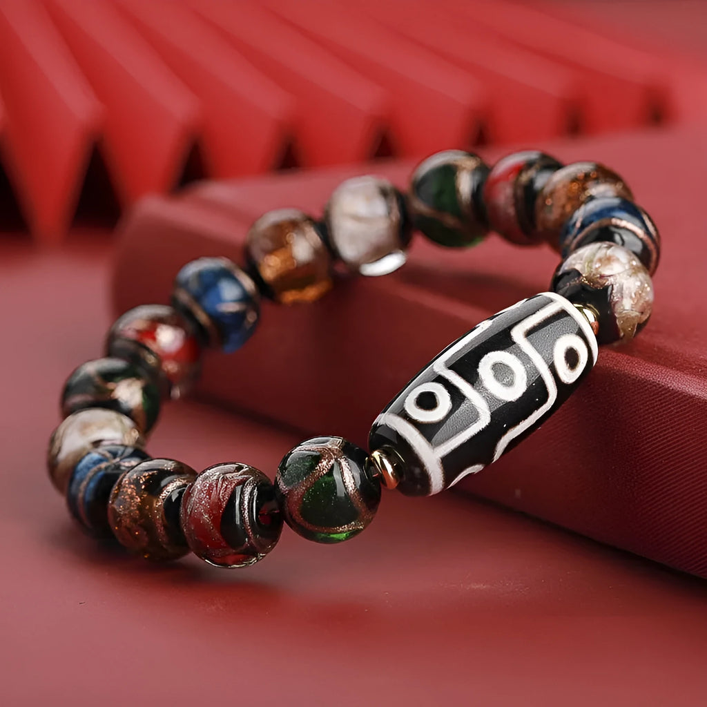 Close-up of a colourful handcrafted Chinese bracelet with snake lucky beads and auspicious patterns.