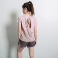 Women's short sleeve polyester sports t-shirt in pink, shown in a casual athletic style.