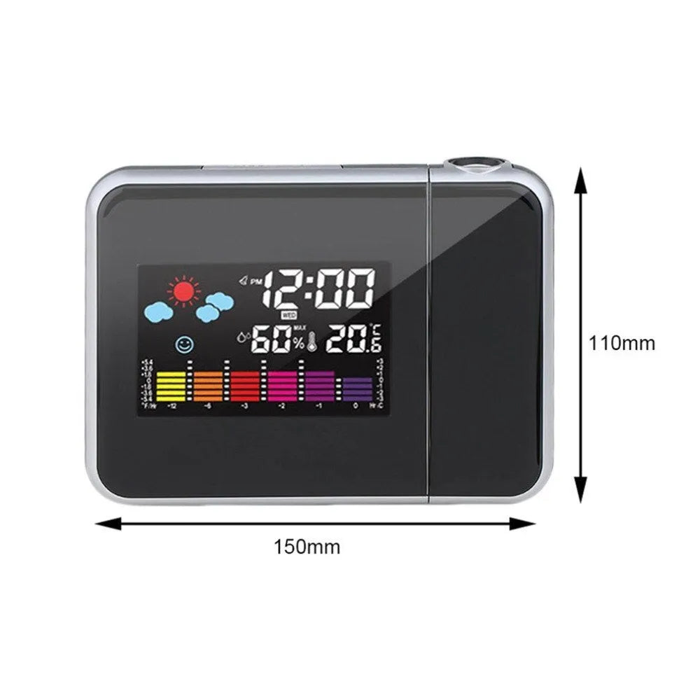 Black digital projection alarm clock with multicolour LED display on a bedside table.