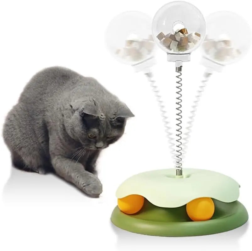 Blue and green interactive cat treat dispenser toy with track ball, shown dismantled for cleaning.
